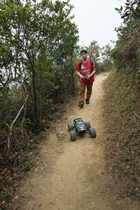 Operating a remote‐controlled toy truck on a walking trail, Ma On Shan Country Park, 15 February 2015