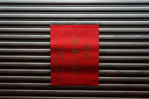 A poster with Lunar New Year greetings taped onto the closed shutters of a shop, Sheung Wan, 18 February 2015