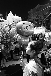 A girl holding a balloon at the Lunar New Year Fair, Victoria Park, Causeway Bay, 18 February 2015