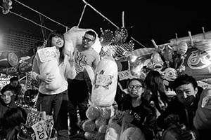 Young people selling goods at a booth in the Lunar New Year Fair, Victoria Park, Causeway Bay, 18 February 2015