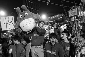 Young people selling goods at a booth in the Lunar New Year Fair, Victoria Park, Causeway Bay, 18 February 2015