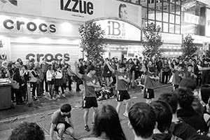 Young people performing on the street in front of Island Beverley Shopping Centre on Lunar New Year Eve, East Point Road, Causeway Bay, 18 February 2015