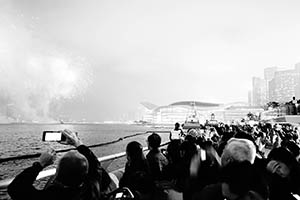 Crowd viewing the Lunar New Year Fireworks Display at the Central harbourfront with the Convention and Exhibition Centre and other buildings in Wanchai in the distance, 20 February 2015