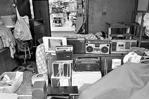 Used electrical appliances for sale on the street, with a man sleeping behind them, Sham Shui Po, 21 February 2015