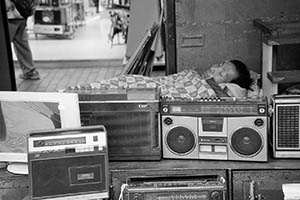 Used electrical appliances for sale on the street, with a man sleeping, Sham Shui Po, 21 February 2015