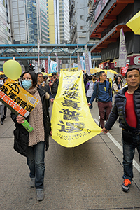 Participants holding a banner, on a pro-democracy march from Victoria Park to Central, Hennessy Road, 1 February 2015
