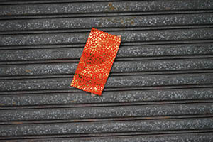 Red paper on the shutters of a closed shop, Tai Kok Tsui, 21 February 2015