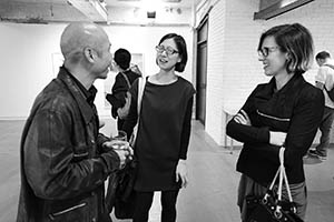 Artist Leung Chi-Wo chatting with guests at an exhibition opening, Blindspot Gallery, Wong Chuk Hang, 7 March 2015
