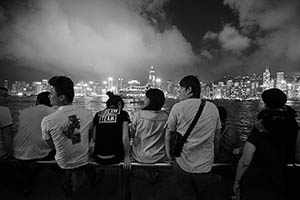 People on the waterfront at night, with a view towards Victoria Harbour and Hong Kong Island, Tsim Sha Tsui, 15 May 2015