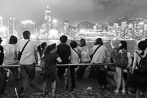 People on the waterfront at night, with a view of Victoria Harbour and Hong Kong Island, Tsim Sha Tsui, 15 May 2015