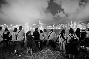 People on the waterfront at night, with a view of Victoria Harbour and Hong Kong Island, Tsim Sha Tsui, 15 May 2015