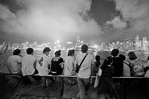 People on the waterfront at night, with a view of Victoria Harbour and Hong Kong Island, Tsim Sha Tsui, 15 May 2015