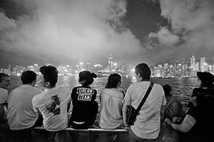 People on the waterfront at night, with a view of Victoria Harbour and Hong Kong Island, Tsim Sha Tsui, 15 May 2015