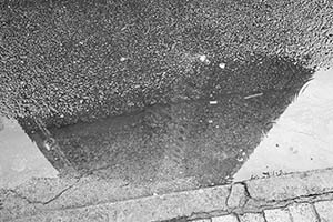 Puddle of rain water with reflection, Sheung Wan, Hong Kong Island, 20 May 2015