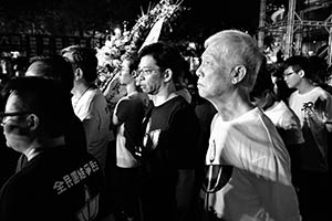 Carrying a funeral wreath at the annual memorial rally in Victoria Park, 4 June 2015