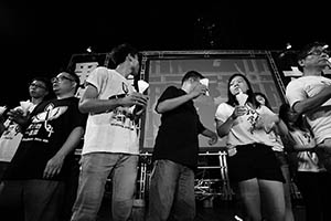 People on the stage holding up candles during the June 4th memorial rally, Victoria Park, 4 June 2015