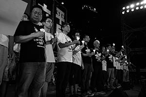 People on the stage holding up candles during the June 4th memorial rally, Victoria Park, 4 June 2015