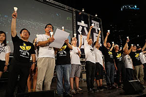People holding up candles on stage during the June 4th memorial rally, Victoria Park, 4 June 2015