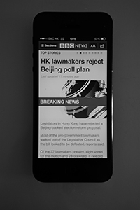 News that Hong Kong Legislators have rejected a Beijing-backed election reform proposal, Sheung Wan, 18 June 2015