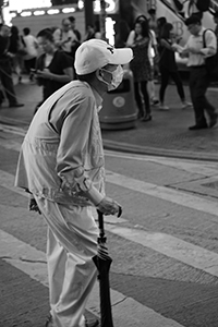 Man with a mask crossing East Point Road, Causeway Bay, 29 October 2015