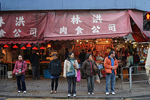 People crossing the road in front of a butcher's shop, Ma Tau Kok Road, To Kwa Wan, 19 December 2015