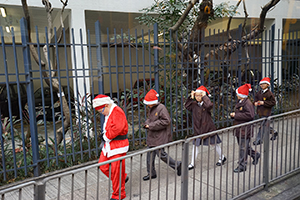 Students going to school wearing Christmas hats, Pokfulam Road, Hong Kong Island, 7 December 2015