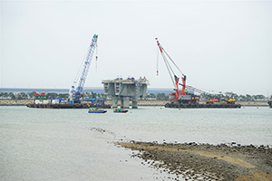 Construction of the Hong Kong - Zhuhai - Macau bridge, with the Hong Kong International Airport at Chek Lap Kok visible behind, 20 March 2016