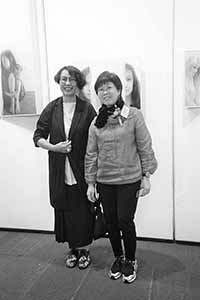 Debbie Cloke (left) at her graduation show, City Hall Exhibition Hall, with photographer Wong Wo Bik, Central, 15 April 2016