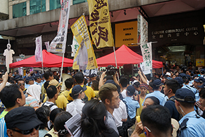 Demonstrators and police at the annual protest march, Hennessy Road, Causeway Bay, 1 July 2016