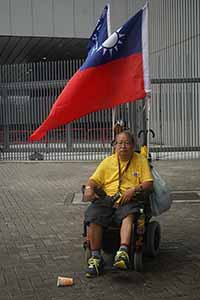 Demonstrator in wheelchair with Taiwanese flag at the annual protest march, Admiralty, 1 July 2016