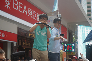 Joshua Wong (left) addressing demonstrators at the annual protest march, Yee Wo Street, Causeway Bay, 1 July 2016