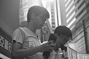 Joshua Wong (front) addressing demonstrators at the annual protest march, Yee Wo Street, Causeway Bay, 1 July 2016