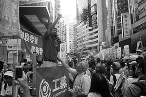 Lee Cheuk-yan of the Labour Party addressing demonstrators at the annual protest march, Hennessy Road, Causeway Bay, 1 July 2016