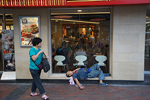 A man resting outside McDonald's, Sham Shiu Po, 6 October 2016