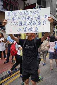 Man with a sign, annual pro-democracy march from Victoria Park, Great George Street, Causeway Bay, 1 July 2017
