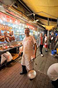 Staff member at a roast meat store, Wing Lung Street, Kowloon, 5 February 2019