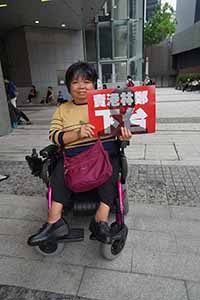 Protester with a sign requesting that Carrie Lam step down, in the area outside the entrance to the Legislative Council, Admiralty, 4 May 2019