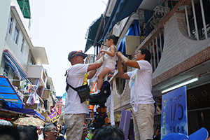 Child on a float being prepared for the parade, Cheung Chau Bun Festival, 12 May 2019