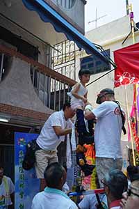 Child on a float, being prepared for the parade, Cheung Chau Bun Festival, 12 May 2019