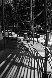 Shadows of scaffolding on the street, Kowloon, 2 June 2019