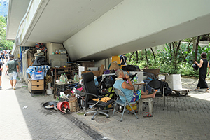 Homeless man with his belongings, under an overhead walkway near Harcourt Garden, Wanchai, 21 June 2019