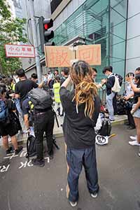 Anti-extradition bill protester with a sign, outside Wanchai Police Headquarters, Arsenal Street, 21 June 2019