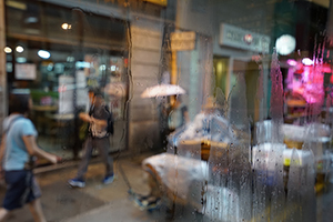 Shops on Queen's Road West, seen through a bus window on a rainy day, 25 June 2019