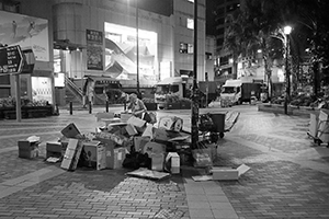 A man sorting cardboard for recycling, Sheung Wan Cultural Square, Bonham Strand, 27 June 2019