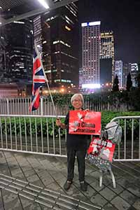 'Grandma Wong' waving a British flag on the footbridge from the Admiralty Centre to the Central Government Offices Complex, 11 June 2019