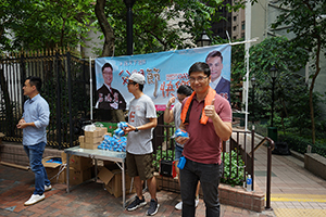 Pro-Beijing politicians from the FTU giving away small presents in the street on Father's Day, Queen's Road West, Sheung Wan, Hong Kong Island, 16 June 2019