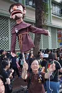 Woman holding a puppet in a march from Causeway Bay to Admiralty against the extradition bill, Wanchai, 16 June 2019