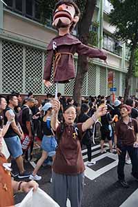 Woman holding a puppet in a march from Causeway Bay to Admiralty against the extradition bill, Wanchai, 16 June 2019