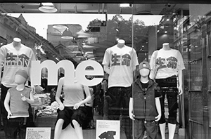 Giordano shop with display of 'cherish life' T-shirts, Nathan Road, 1 May 2002