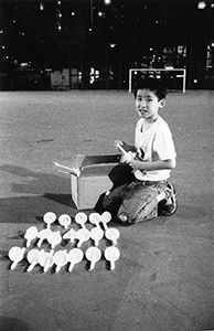 Boy with candles at the June 4th memorial rally, Victoria Park, 4 June 2002